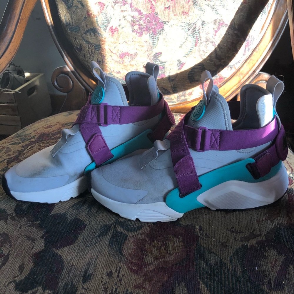 purple, turquoise, and gray Nike shoes